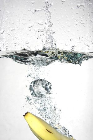 Banana splashing into waterの写真素材