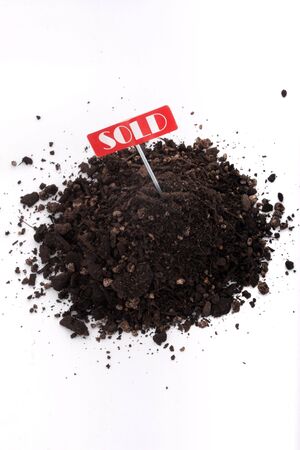 Sold sign and soil isolated on white backgroundの写真素材