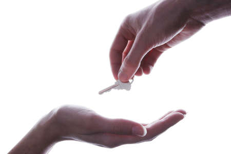 Handing over the key isolated on white backgroundの写真素材