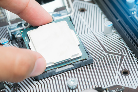 Installing main CPU in socket on computer motherboard,Close up shot CPU installing on mainboard