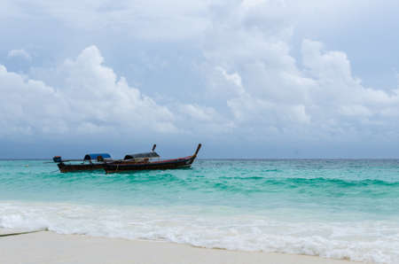 2 Thai traditional long tail boats on the beach, lipe island, Thailandの写真素材