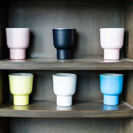 coffee mugs on the shelf in cafeの写真素材