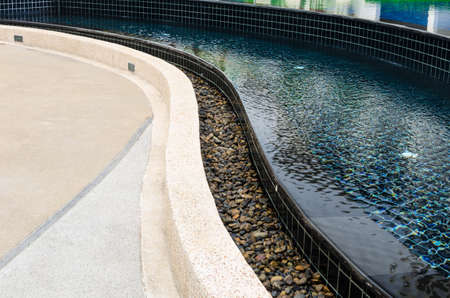 swimming pool with stone edge in the hotelの写真素材