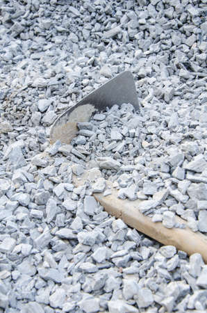 shovel under the pile of gravelの写真素材