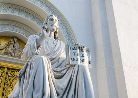 jesus sculpture holding the bookの写真素材