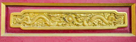 golden dragon wall art at Chinese templeの写真素材
