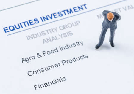 miniature businessman standing on the portfolio investmentの写真素材