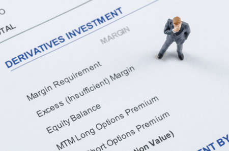 miniature businessman standing on the derivatives investmetnの写真素材