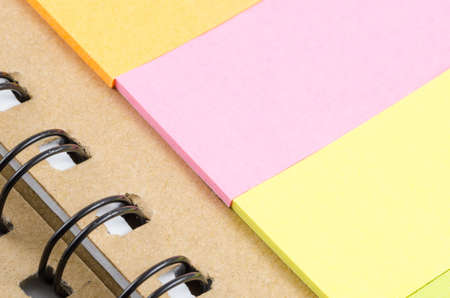 sticky note on the brown notebook