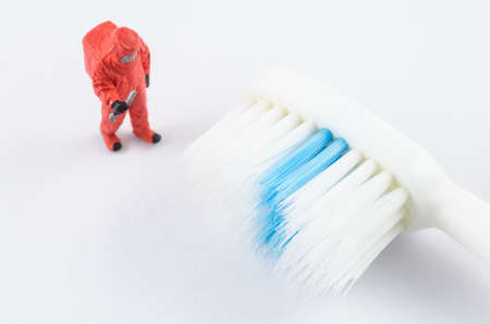 miniature scientist checking bacteria on the toothbrushの写真素材