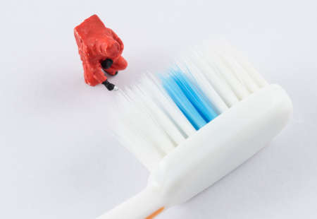 miniature scientist checking bacteria on the toothbrushの写真素材