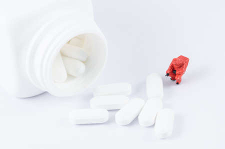 miniature scientist checking toxic on the painkillerの写真素材