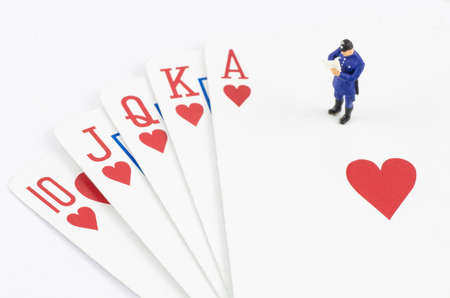miniature policeman standing on the gamble cardの写真素材