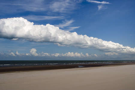 Fluffy white clouds over Dunkirk beach, Franceの写真素材