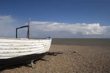 White fishing boat on Dunwich Beach in Suffolk, Englandの写真素材