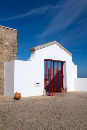 Red gates to the lighthouse at Cape St Vincent, Algarve, Portugalの写真素材