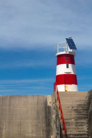 Red and white lighthouse at Sagres, Algarve, Portugal - with space for textの写真素材