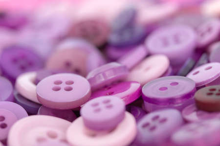Closeup image of pink and purple sewing buttonsの写真素材