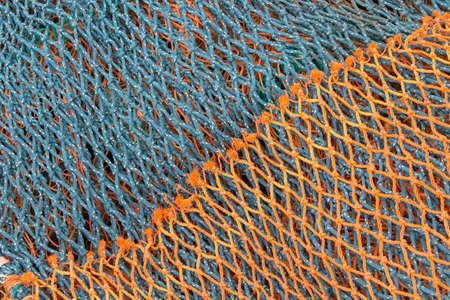 Green and orange fishing netsの写真素材