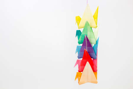 Colourful origami birds against a white background, with space for text