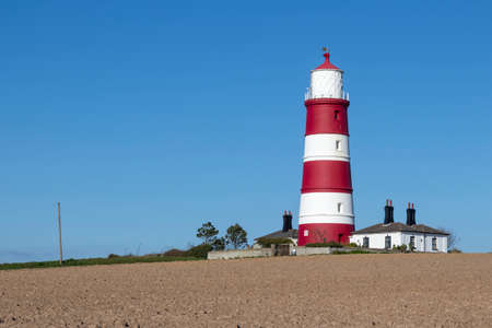 Red and white lighthouse at Happisburgh on the North Norfolk coast, England, United Kingdomの写真素材