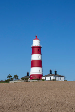 Red and white lighthouse at Happisburgh on the North Norfolk coast, England, United Kingdomの写真素材