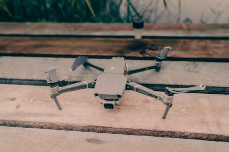 Drone quadcopter with a flight controller and notebook on the old wooden background.のeditorial素材