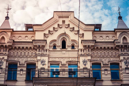 Stucco molding on the top part of a facade of the building against the sky with clouds in Saint-Petersburg, Russiaのeditorial素材