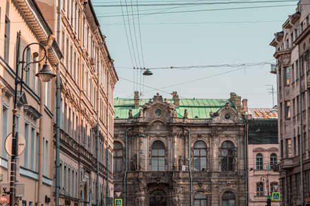 Stucco molding on the top part of a facade of the building against the sky with clouds in Saint-Petersburg, Russiaのeditorial素材