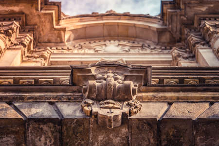 Stucco molding on the top part of a facade of the building against the sky with clouds in Saint-Petersburg, Russiaのeditorial素材