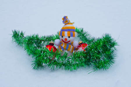 New Year's snowman with toys in the snow.の写真素材