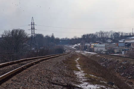 The railway in gloomy winter weather is an interesting screensaver for the gadget.の写真素材