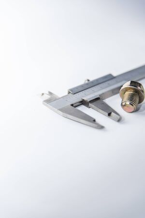 vernier tool measure bolt size on white background, selective focusの写真素材