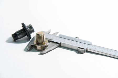 vernier tool measure bolt size on white background, selective focus