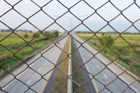 secondary interstate highway less of traffic, metal net fence protect some accident