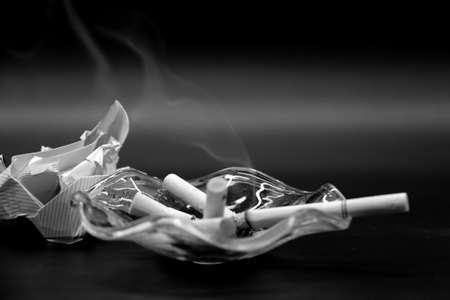 Smoking cigarettes ash and ashtrayの写真素材