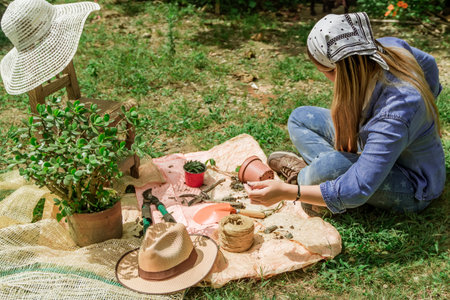 Latin woman sitting in the gardenの写真素材