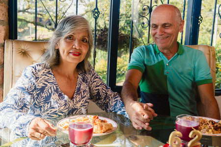 May 12 Mother's Day. Beautiful mother celebrating very happy her birthday next to her husband. In love. Cake.の写真素材