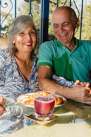 May 12 Mother's Day. Beautiful mother celebrating very happy her birthday next to her husband. In love. Cake.の写真素材