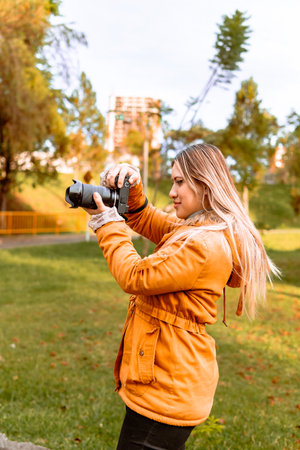 Latina woman photographer on a hot day taking pictures on vacation. Nature and sunlight. World...