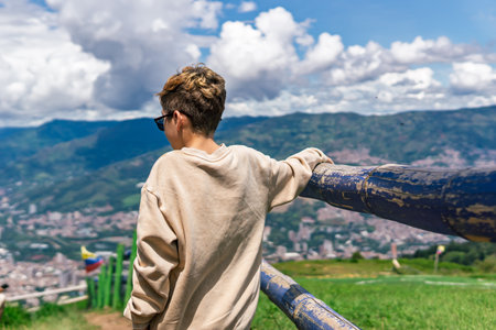 Portrait of a smiling 11 year old Latino boy outdoors on a sunny day, wearing casual clothes, looking confident and happyの写真素材