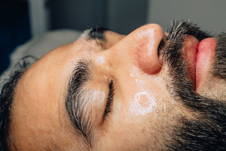 Close-up photo of professional exfoliation, moisturizing and facial cleansing treatment for a...