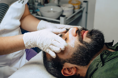 Photo of professional exfoliation, moisturizing and facial cleansing treatment for an adult...