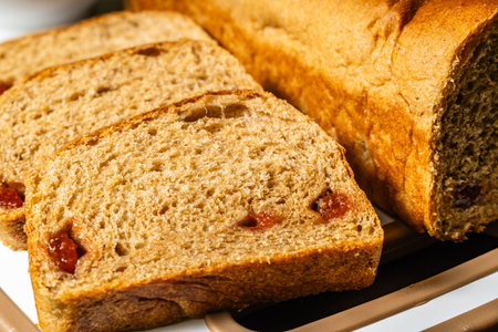 horizontal close-up photo of traditional artisan whole wheat sliced bread with guava jam.の写真素材