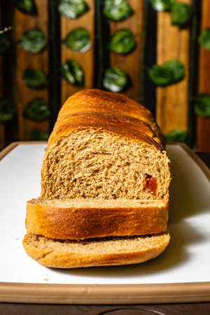 Vertical photo of traditional whole wheat artisan bread sliced with guava jam at a healthy...