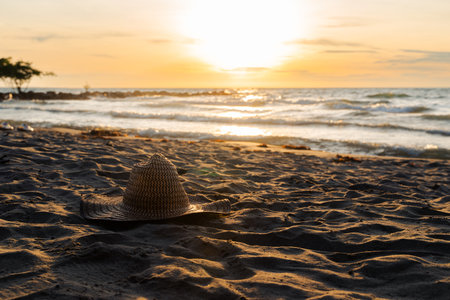 Traditional Colombian coastal hat on sandy beach at sunset near CoveÃ±as, Caribbean coast.の写真素材