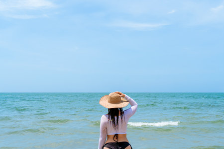 Woman with Caribbean braids and traditional hat standing in the sea, CoveÃ±as coast, Colombia.の写真素材