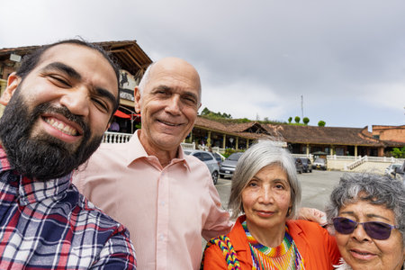 Colombian multigenerational family taking selfie in mountain setting near rustic restaurant in Guarne, Antioquiaの写真素材