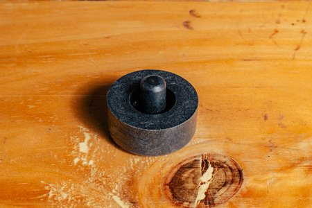 Flexible synthetic cap placed on wooden surface with concentric cylindrical design