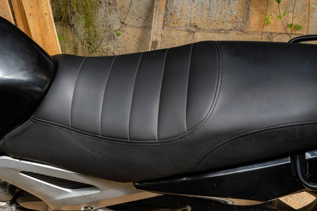 Black motorcycle seat with horizontal stitching and padded sections for comfortの写真素材